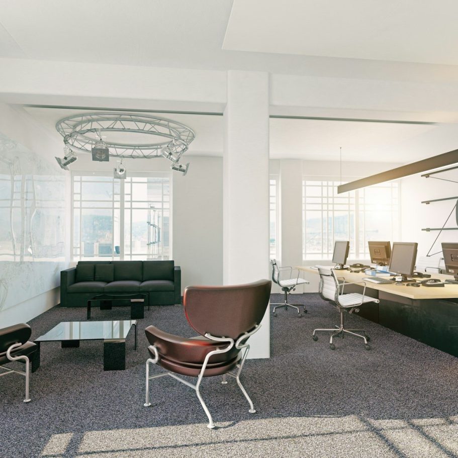 Office interior design with a lounge area and commercial office desk setups.